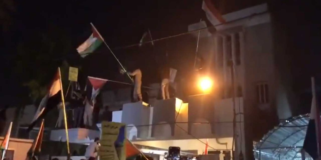Iraqis storm Bahrain embassy in Baghdad; wave Palestinian flags from roof of building