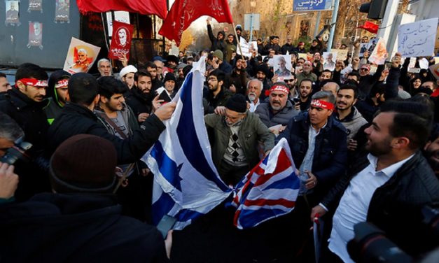 Iranian militia surround UK embassy in Tehran, burn British and Israel flags, amid escalating tensions between Britain and Iran