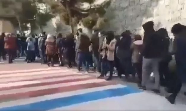 WATCH: Iranian students AVOID walking over giant US and Israel flags